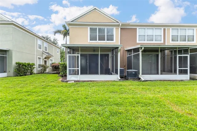 a view of a house with a yard and porch