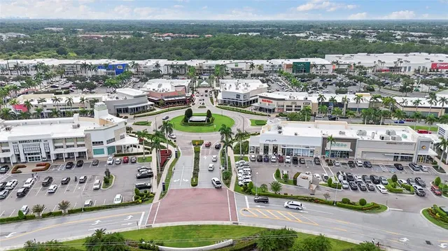 an aerial view of a house with a garden and street view