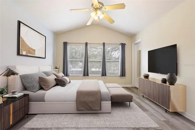 a bedroom with a bed and a flat screen tv