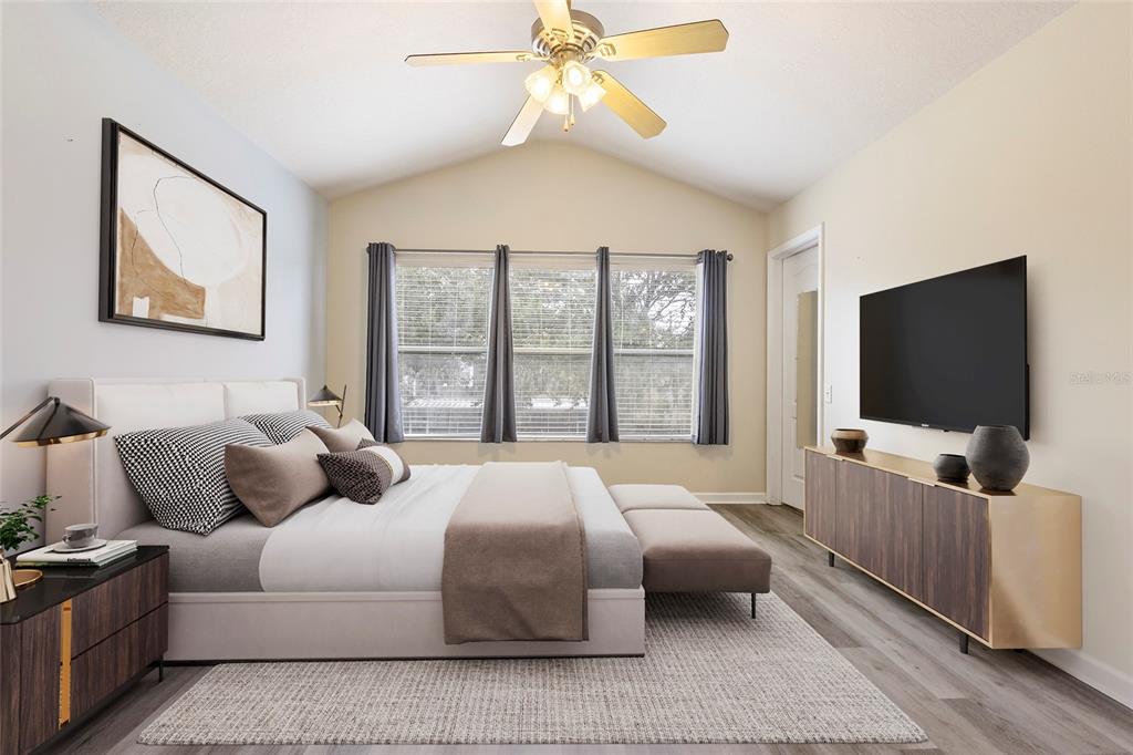 8324 72nd Lane East Bradenton, FL 34201 - Photo 9 of 50 a bedroom with a bed and a flat screen tv