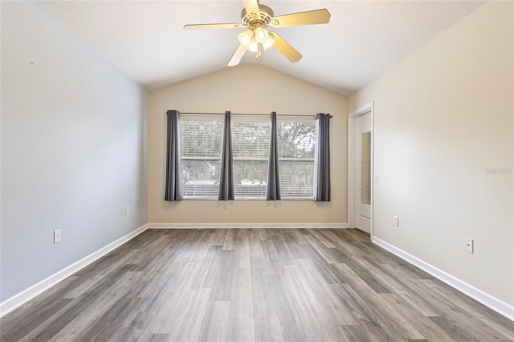 8324 72nd Lane East Bradenton, FL 34201 - Photo 10 of 50 a view of an empty room with wooden floor and a window