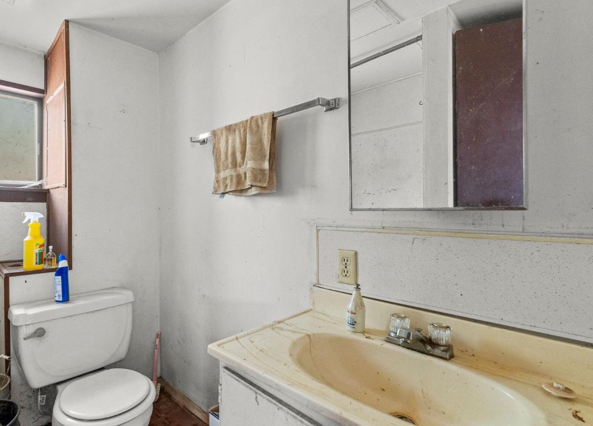 13433 Newtown Road Nevada City, CA 95959 - Photo 30 of 33 a bathroom with a granite countertop sink a toilet and a mirror