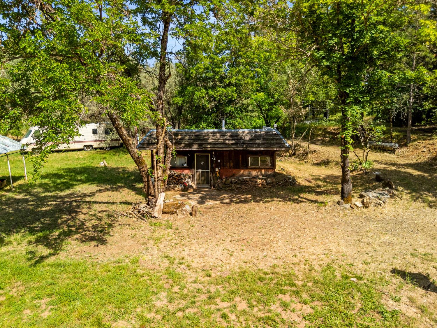13433 Newtown Road Nevada City, CA 95959 - Photo 3 of 33 a backyard of a house with a yard and outdoor seating