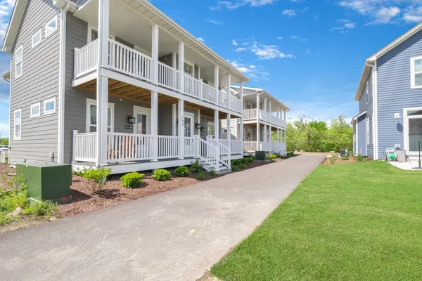 a front view of a house with a yard and a garage