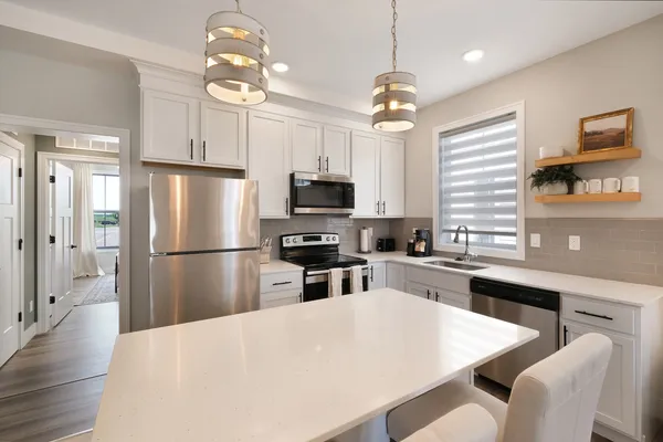 a kitchen with refrigerator cabinets and wooden floor