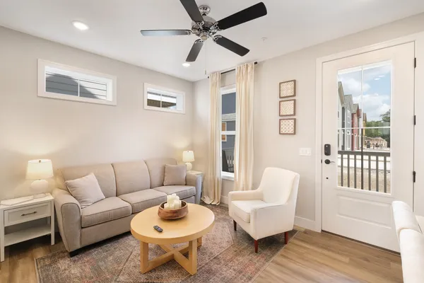 a living room with furniture and a wooden floor