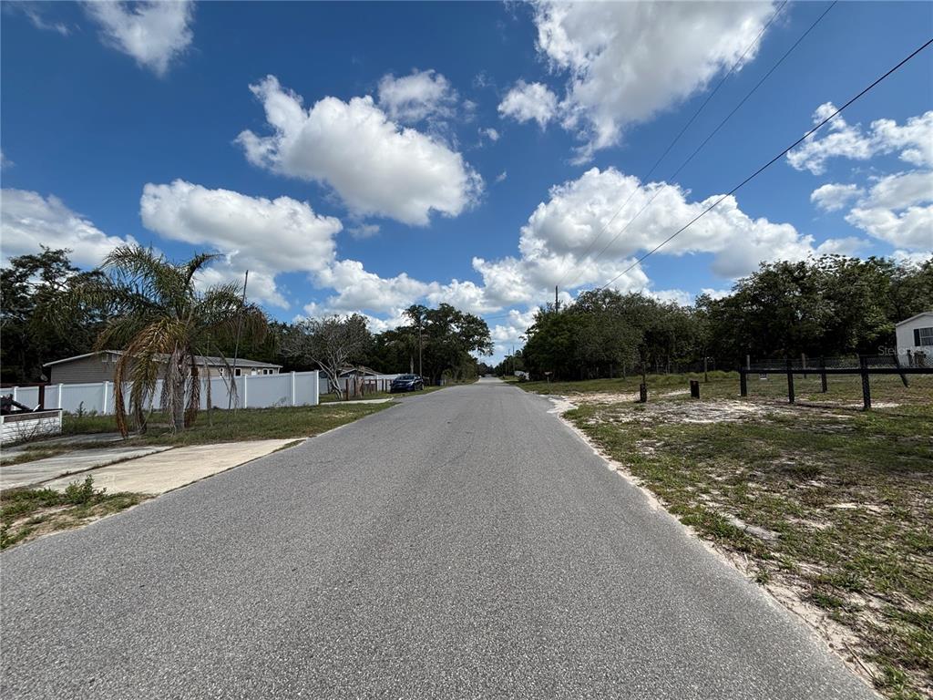 15546 Hicks Road Hudson, FL 34667 - Photo 7 of 8 a view of a street with a yard