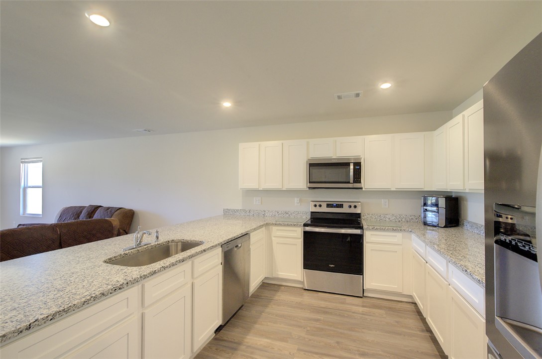 408 Chadwick Lane Walhalla, SC 29691 - Photo 9 of 44 A well-appointed kitchen features ample counter space, bright cabinetry, and modern stainless steel appliances.