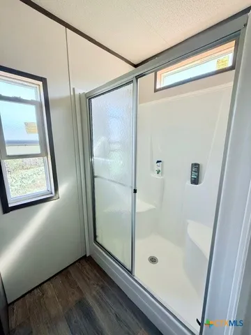 a bathroom with a glass shower door