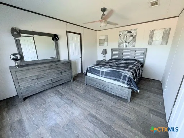 a bedroom with a bed and a mirror