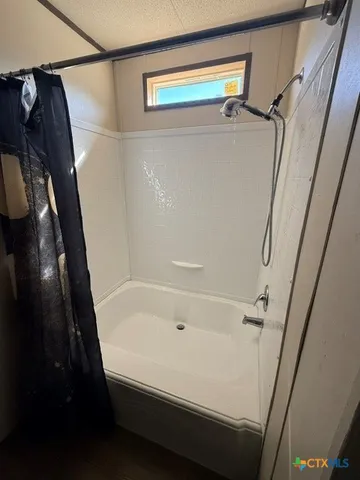 a bathroom with a bathtub and a shower