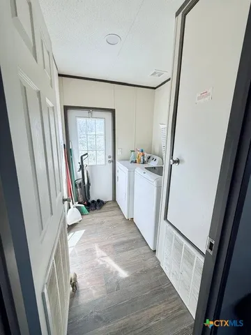 a view of a kitchen with refrigerator sink and wooden floor