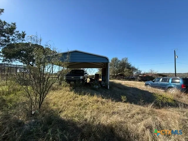 a view of a yard with large trees