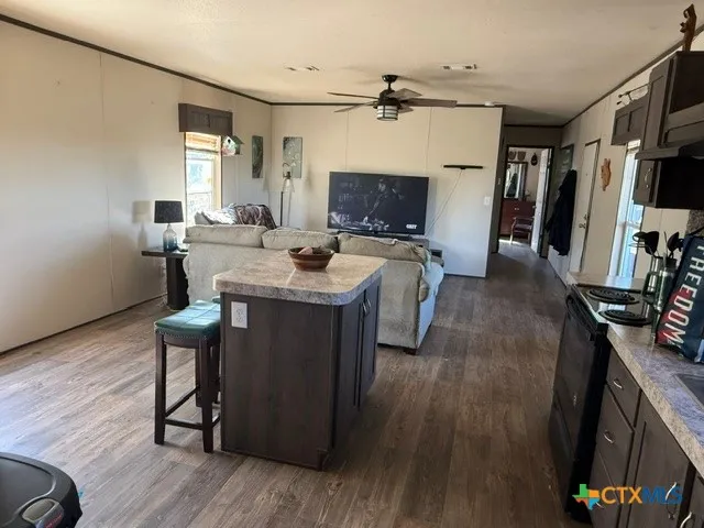 a view of a workspace with furniture wooden floor and a flat screen tv