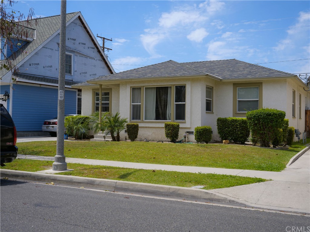 4613 Dunrobin Avenue Lakewood, CA 90713 - Photo 1 of 30 a front view of a house with a yard and porch