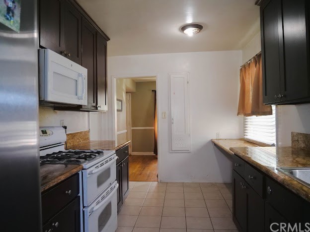 4613 Dunrobin Avenue Lakewood, CA 90713 - Photo 13 of 30 a kitchen with granite countertop a sink stove and refrigerator