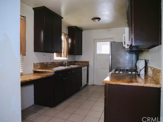 4613 Dunrobin Avenue Lakewood, CA 90713 - Photo 14 of 30 a kitchen with a sink stove and cabinets