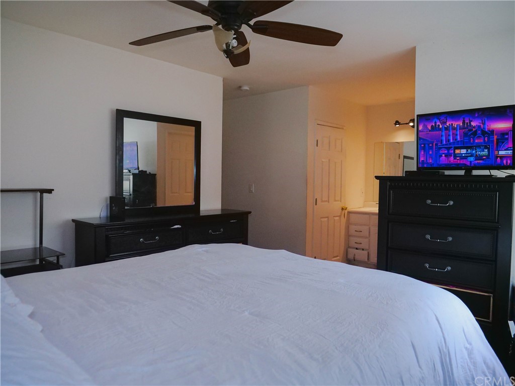 4613 Dunrobin Avenue Lakewood, CA 90713 - Photo 15 of 30 a bedroom with a bed and a flat tv screen on dresser