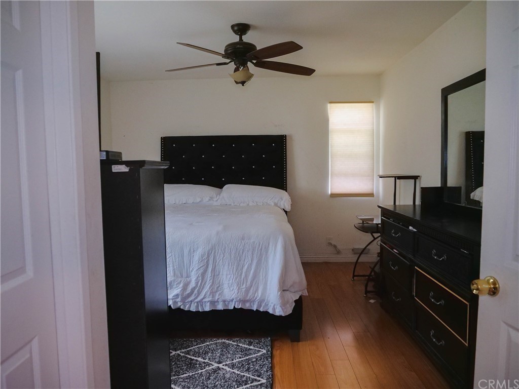 4613 Dunrobin Avenue Lakewood, CA 90713 - Photo 19 of 30 a bedroom with a bed and wooden floor
