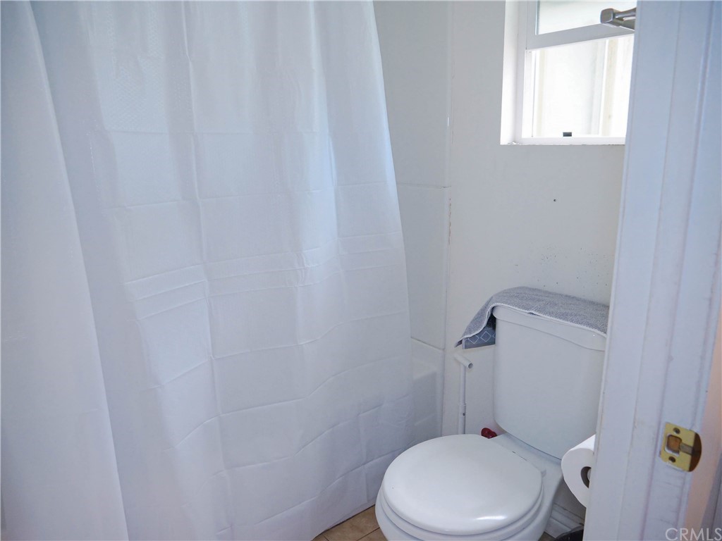 4613 Dunrobin Avenue Lakewood, CA 90713 - Photo 22 of 30 a white toilet sitting next to a window