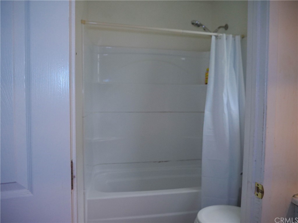 4613 Dunrobin Avenue Lakewood, CA 90713 - Photo 23 of 30 a bathroom with a shower and a toilet