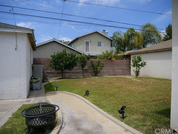 4613 Dunrobin Avenue Lakewood, CA 90713 - Photo 28 of 30 a front view of a house with a yard