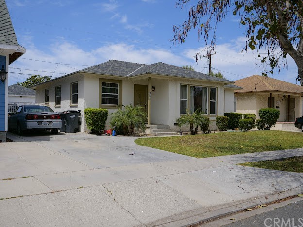 4613 Dunrobin Avenue Lakewood, CA 90713 - Photo 3 of 30 a front view of a house with a garden