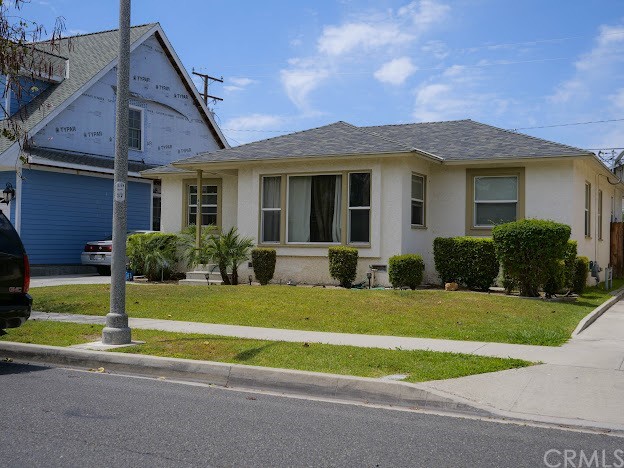 4613 Dunrobin Avenue Lakewood, CA 90713 - Photo 4 of 30 a front view of a house with a yard and porch