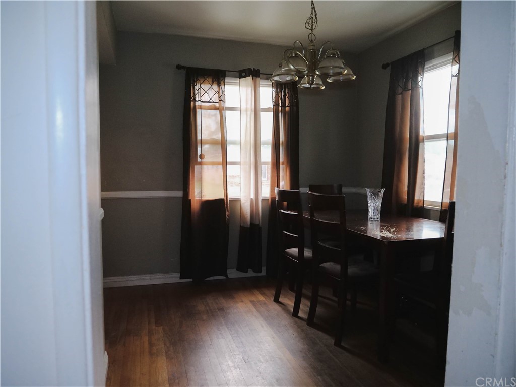 4613 Dunrobin Avenue Lakewood, CA 90713 - Photo 7 of 30 a room with a chandelier and wooden floor