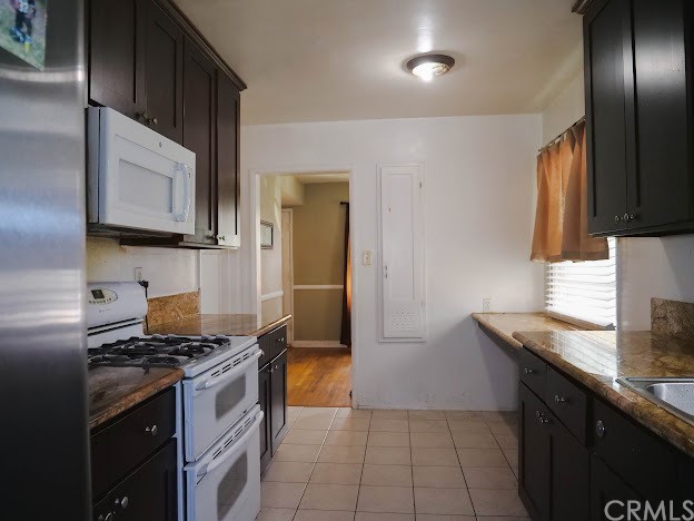4613 Dunrobin Avenue Lakewood, CA 90713 - Photo 10 of 30 a kitchen with granite countertop a sink stove and refrigerator