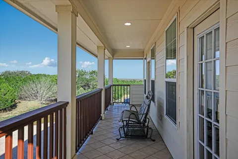 a view of a balcony with chairs