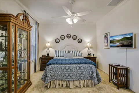 a bedroom with a bed and a chandelier