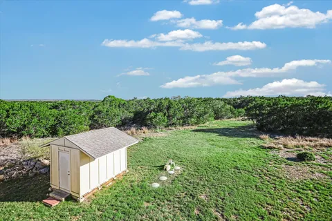 a aerial view of a house with yard and outdoor seating