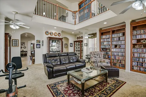 a living room with furniture a rug and a book shelf