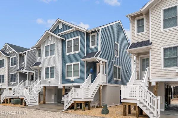 a view of a building with cars parked