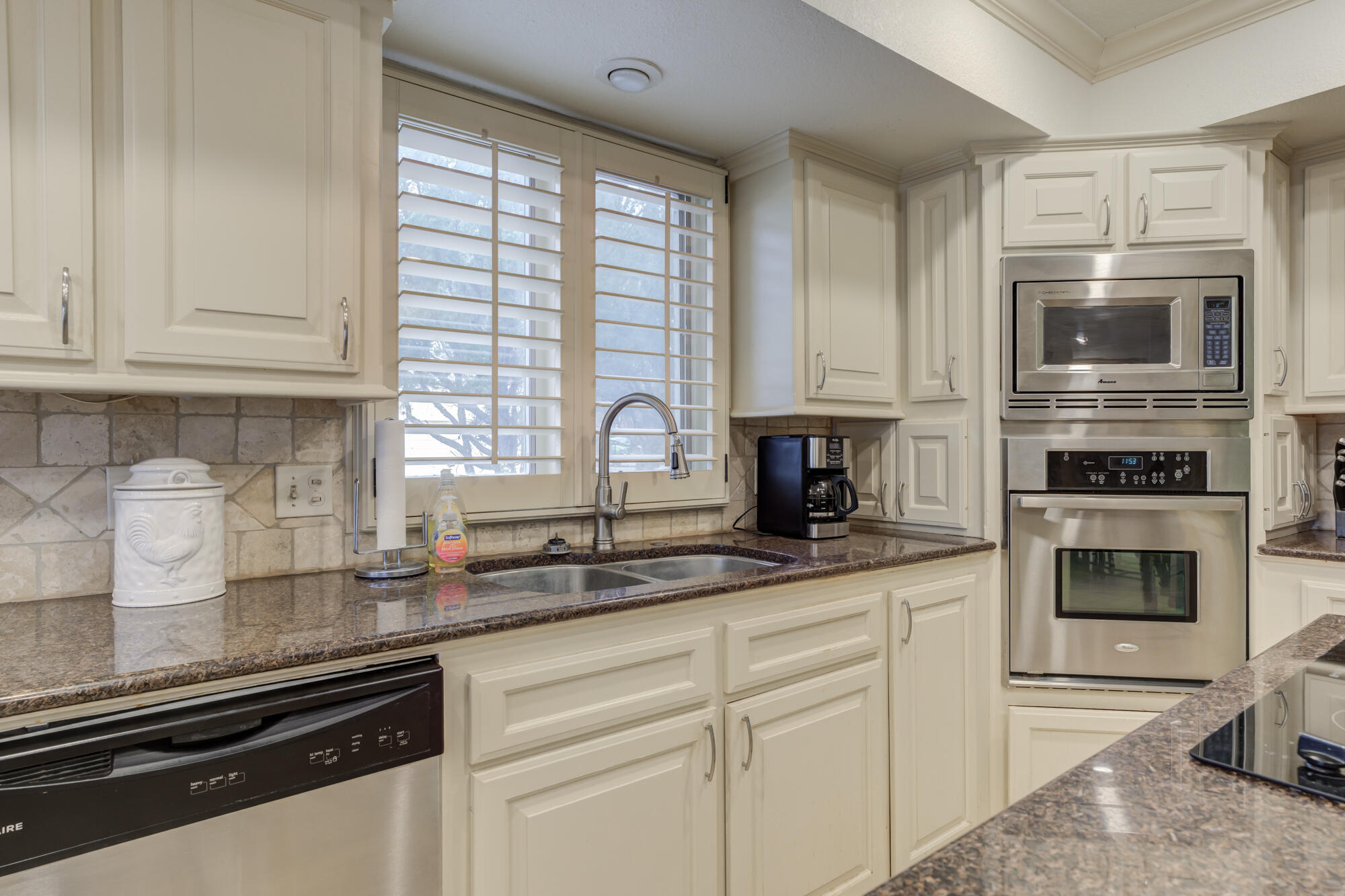 4405 89th Street Lubbock, TX 79424 - Photo 37 of 71 a kitchen with granite countertop a sink stainless steel appliances and cabinets