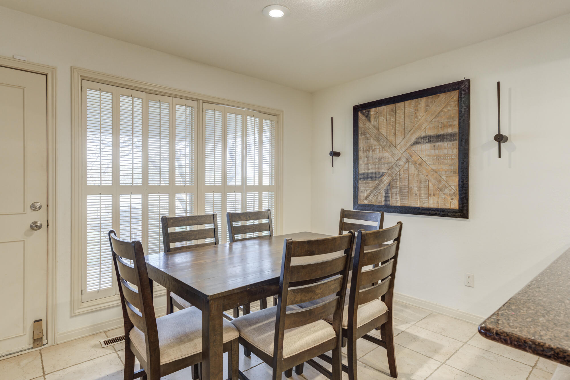 4405 89th Street Lubbock, TX 79424 - Photo 40 of 71 a view of a dining room with furniture large window and wooden floor