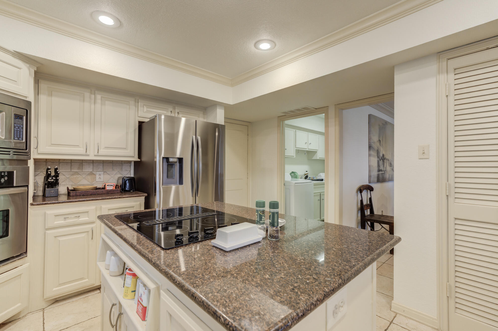 4405 89th Street Lubbock, TX 79424 - Photo 41 of 71 a kitchen with kitchen island granite countertop a sink stove and refrigerator