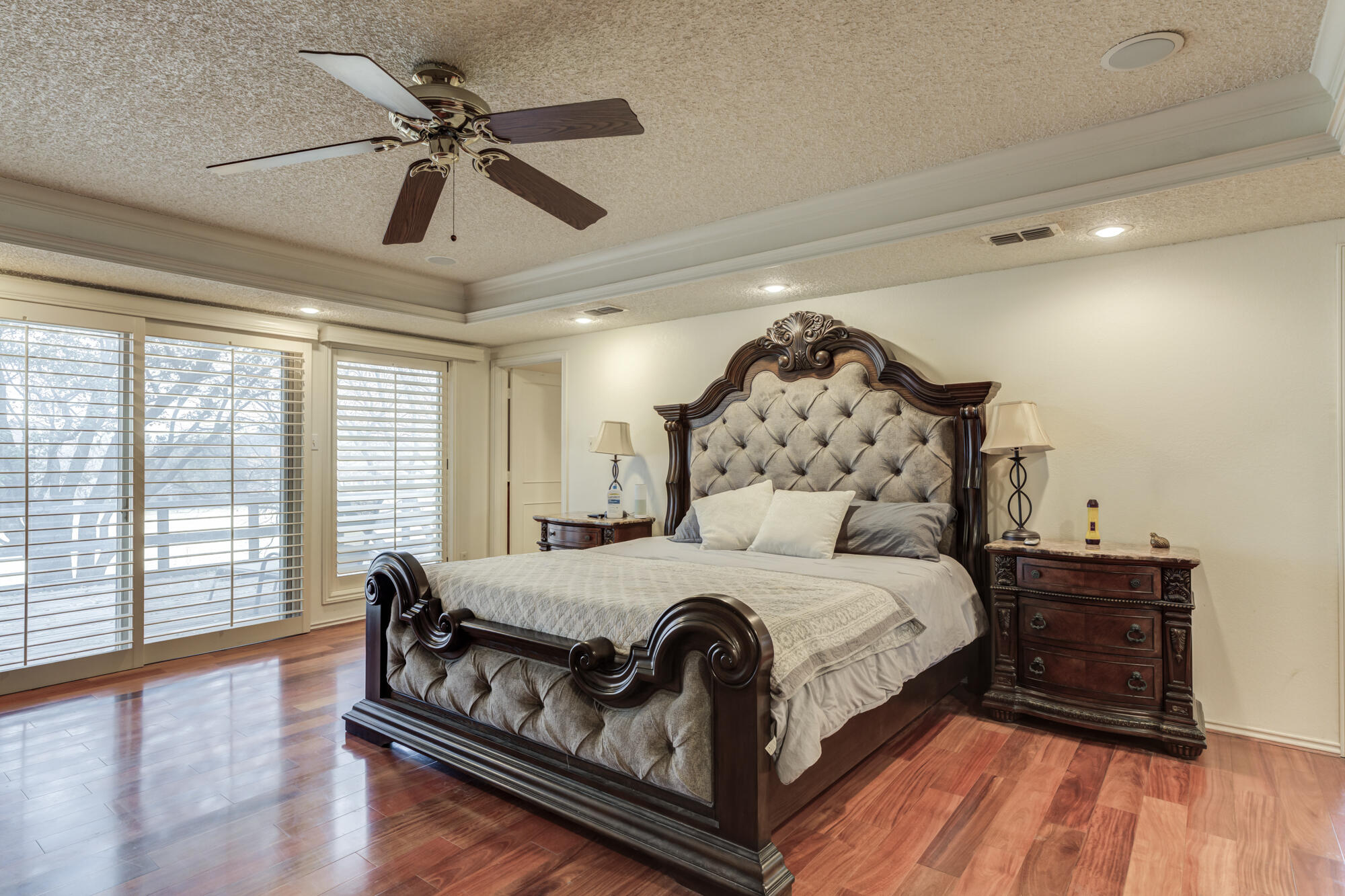 4405 89th Street Lubbock, TX 79424 - Photo 45 of 71 a large bedroom with a bed and wooden floor