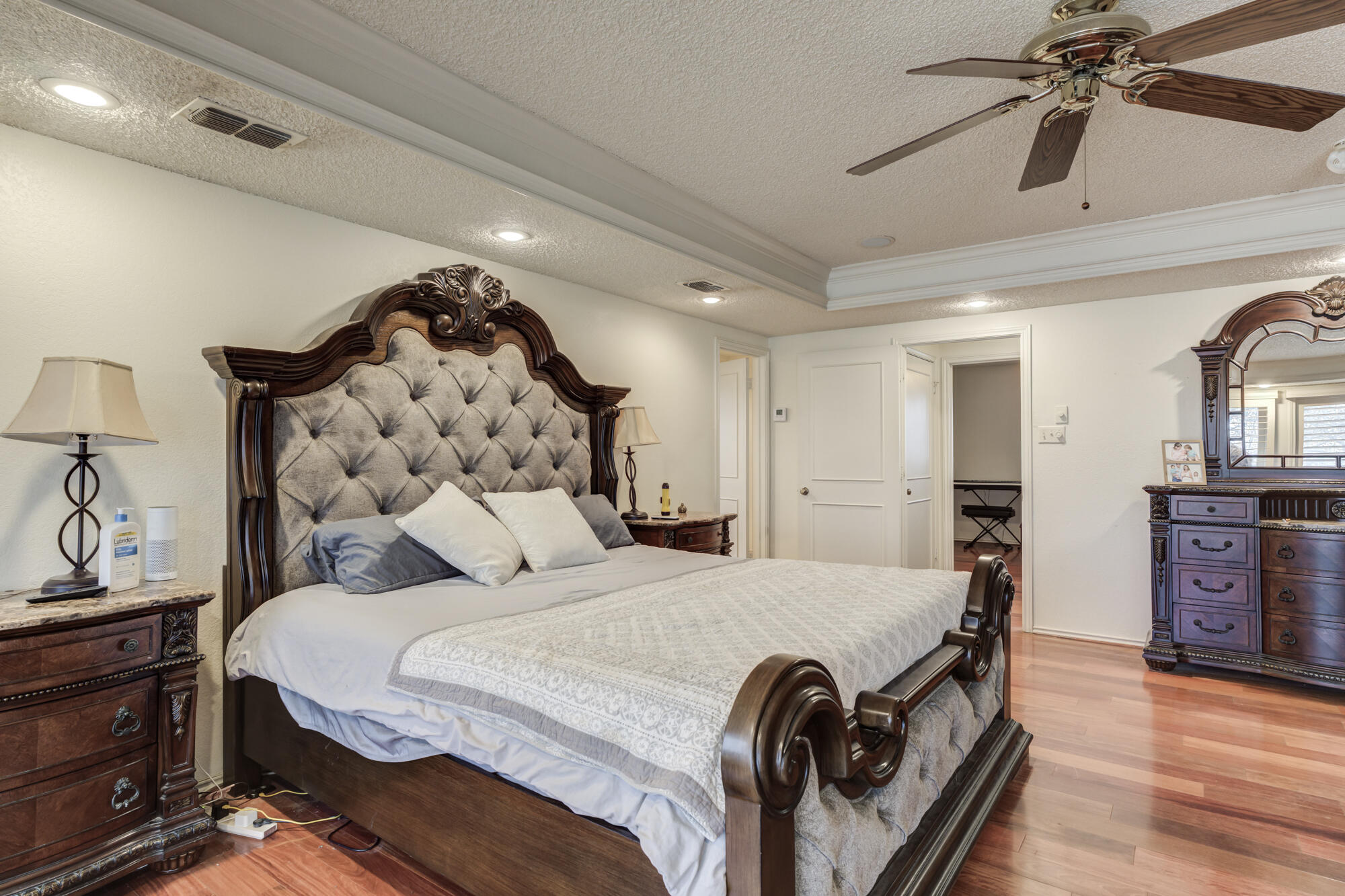 4405 89th Street Lubbock, TX 79424 - Photo 46 of 71 a bedroom with a bed and wooden floor
