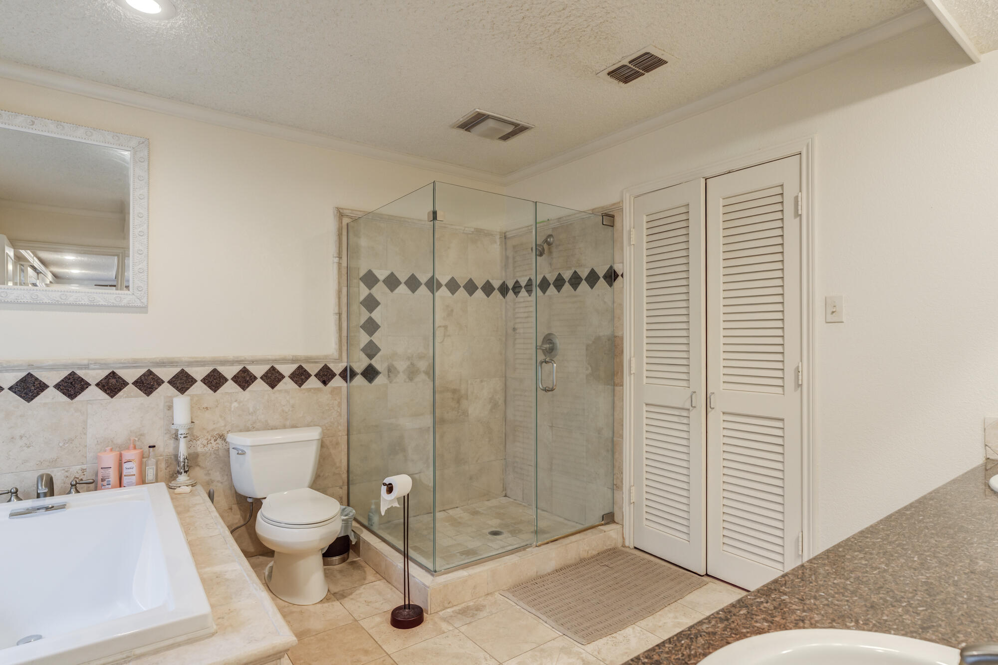 4405 89th Street Lubbock, TX 79424 - Photo 49 of 71 a bathroom with a shower a mirror and a sink
