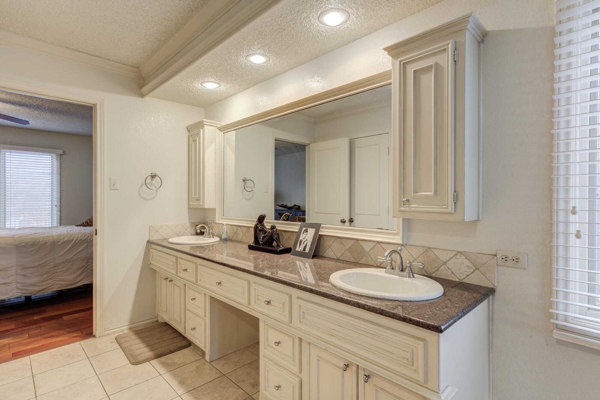 4405 89th Street Lubbock, TX 79424 - Photo 59 of 71 a bathroom with double sink and a mirror