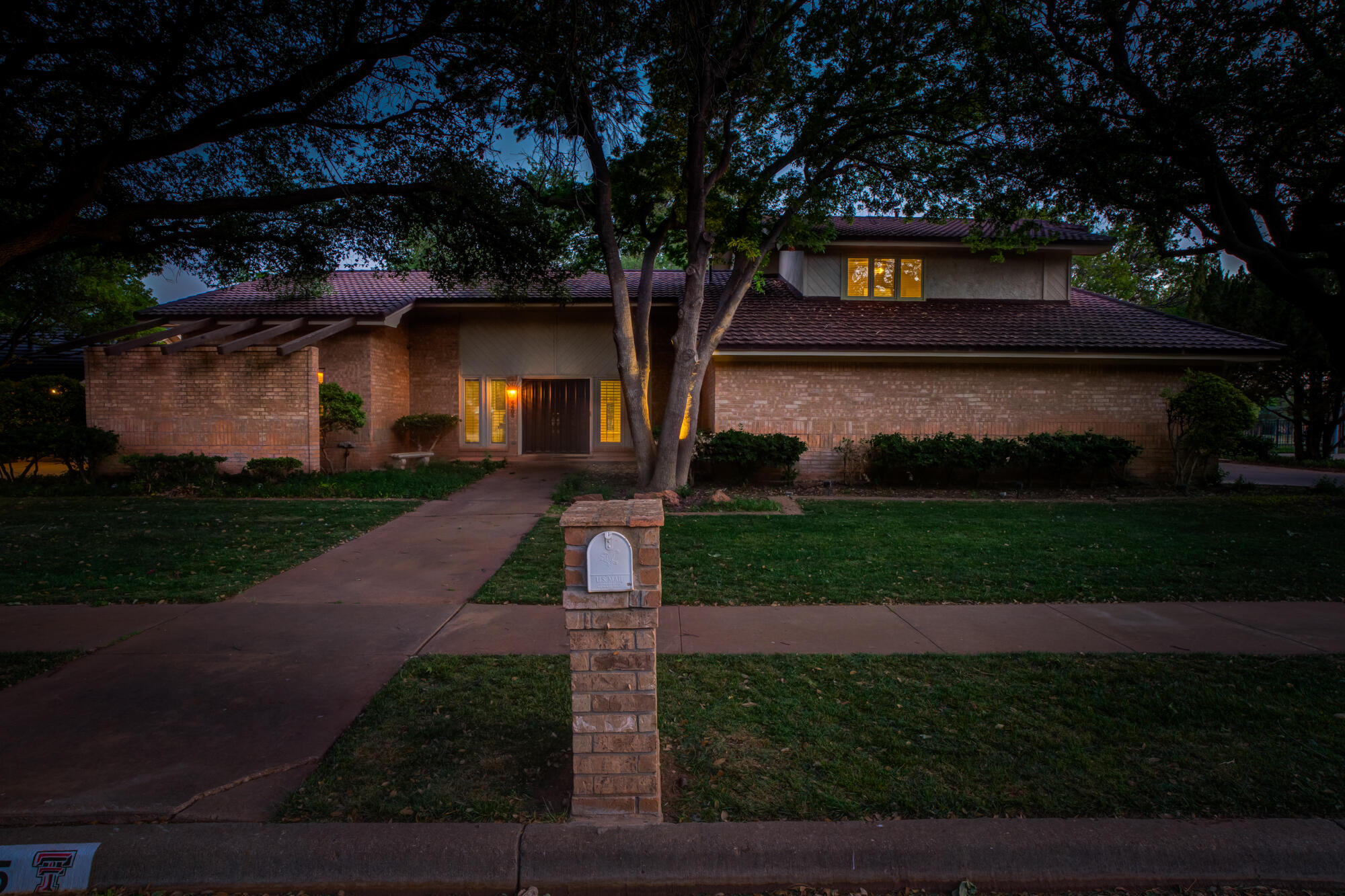 4405 89th Street Lubbock, TX 79424 - Photo 6 of 71 a front view of a house with a yard and garage