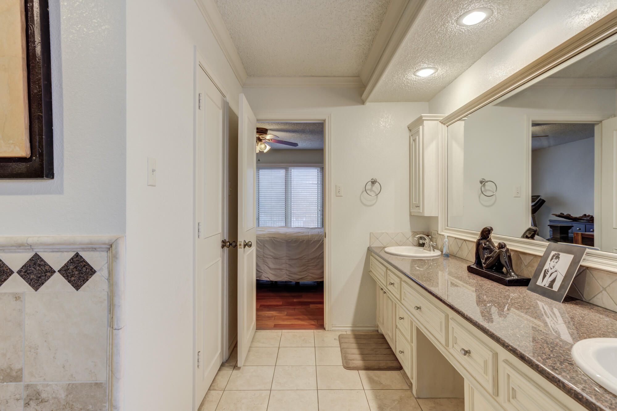 4405 89th Street Lubbock, TX 79424 - Photo 61 of 71 a spacious bathroom with a double vanity sink and a mirror