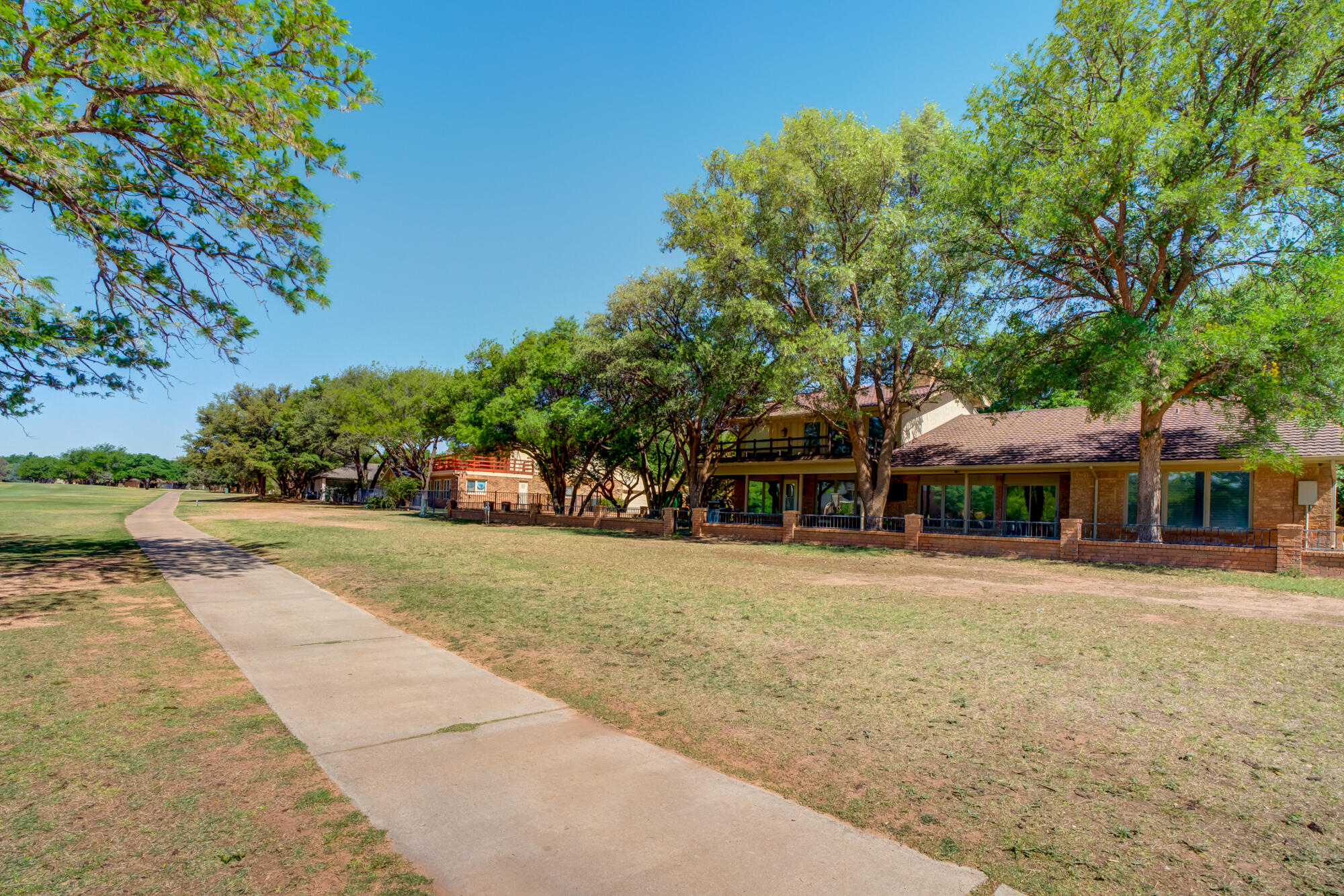 4405 89th Street Lubbock, TX 79424 - Photo 65 of 71 a front view of a house with a yard and trees