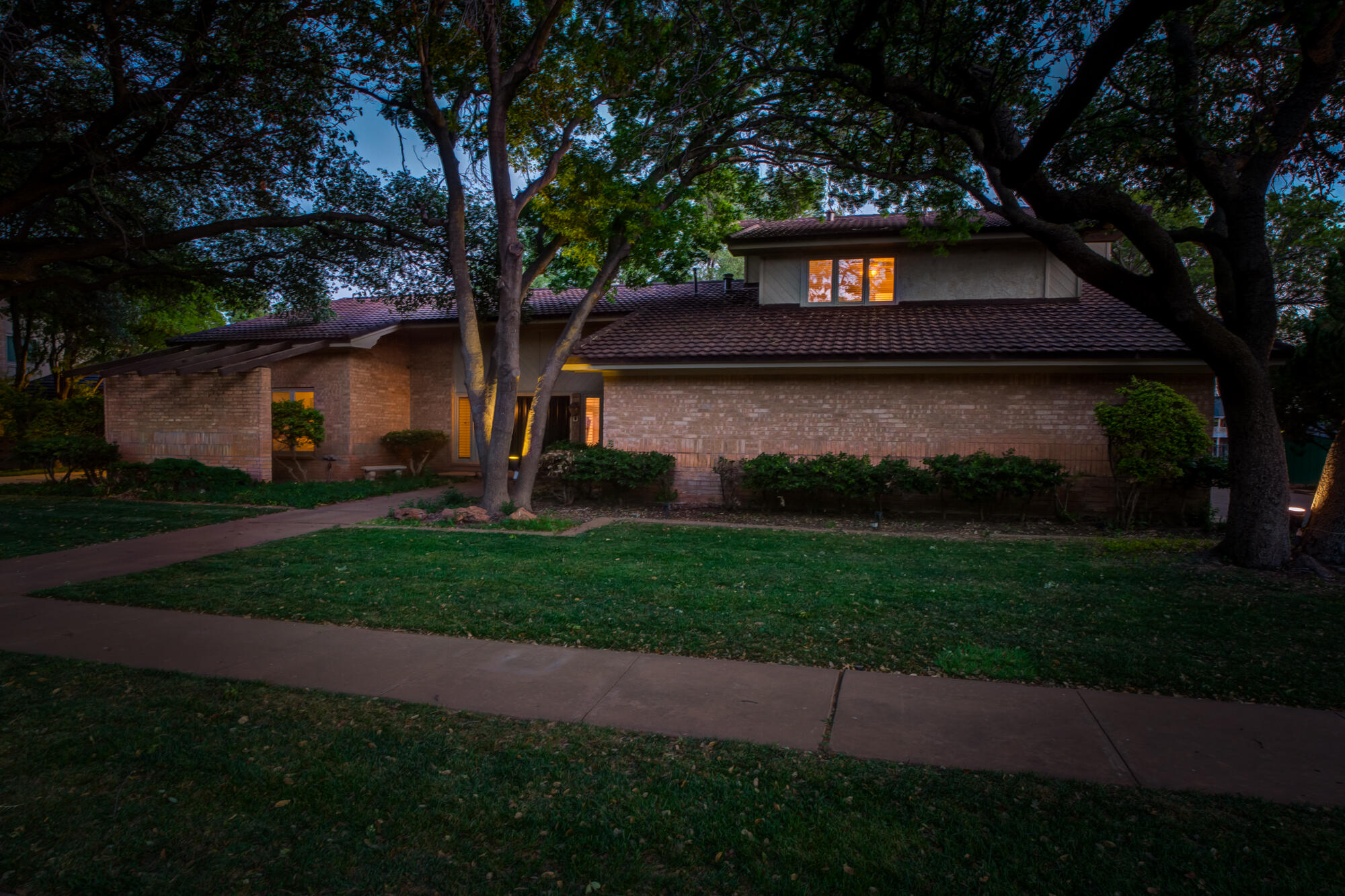 4405 89th Street Lubbock, TX 79424 - Photo 69 of 71 a front view of a house with a garden and tree