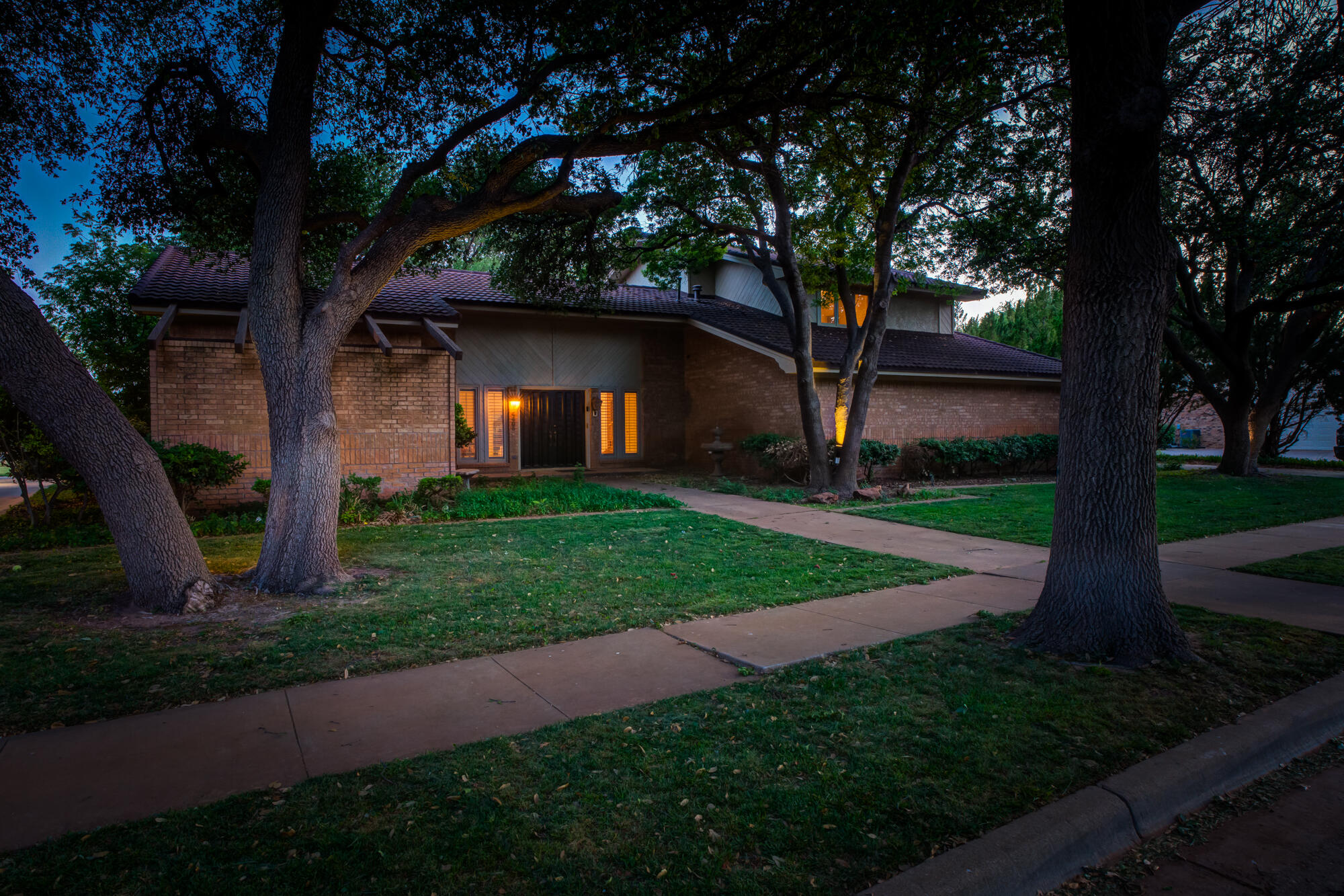 4405 89th Street Lubbock, TX 79424 - Photo 7 of 71 a view of a yard with a large tree