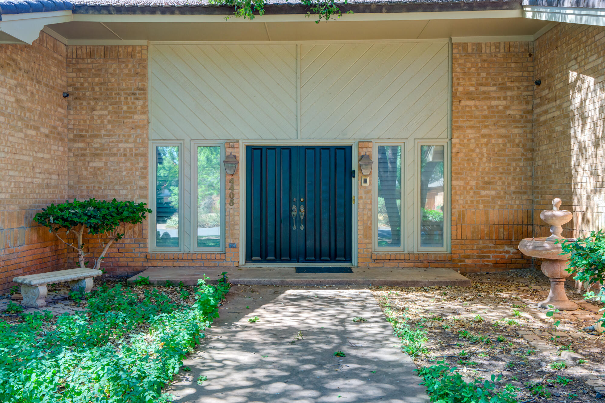 4405 89th Street Lubbock, TX 79424 - Photo 10 of 71 a front view of a house with a yard