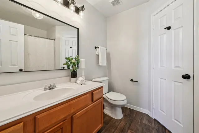 a bathroom with a tub shower vanity and a sink