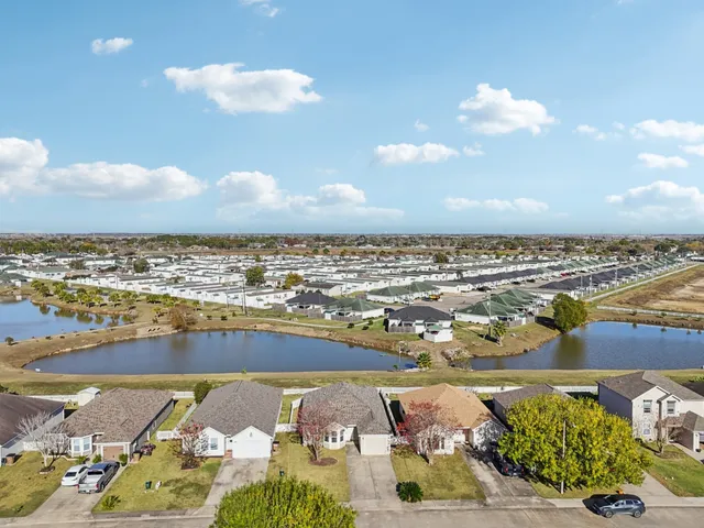 an aerial view of residential houses with outdoor space